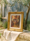 Renaissance style fine art print featuring a woman's lower face with parted coral lips from which delicate white cosmos flowers and botanical elements emerge, painted in warm amber and golden tones with classical oil painting technique, perfect for dark academia gothic home decor and vintage botanical wall art collections.